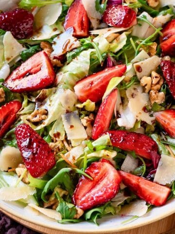 Strawberries Balsamic salad in a bowl with a yellow rim.