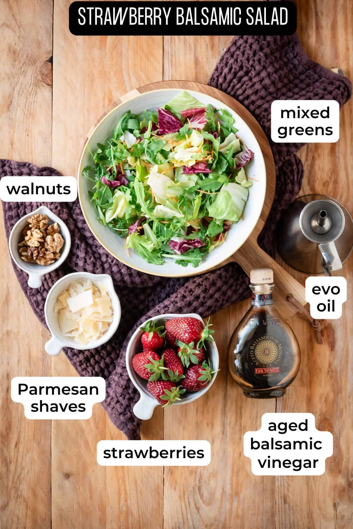 Ingredients needed for strawberries and balsamic salad laid on a wooden surface.
