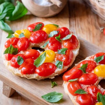 friselle with tomatoes on a wooden board