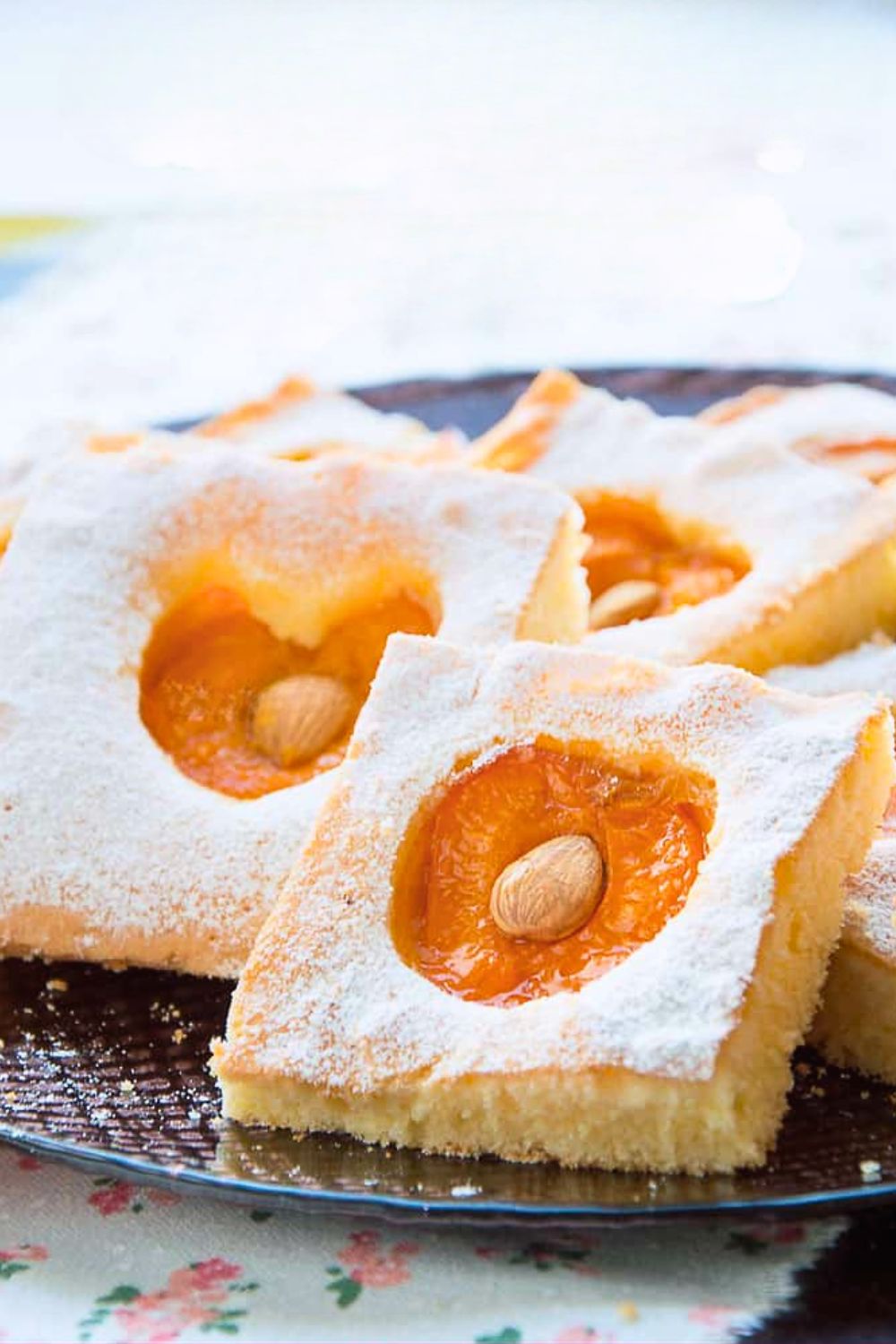 Fresh fruit apricot cake cut into square in a serving plate.