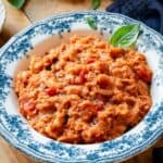 Pappa Al Pomodoro soup in a bowl garnished with a basil leaf.