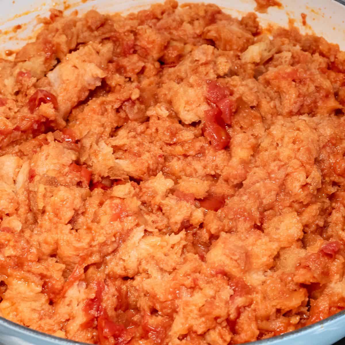 Stale bread with tomatoes cooking in the pot.