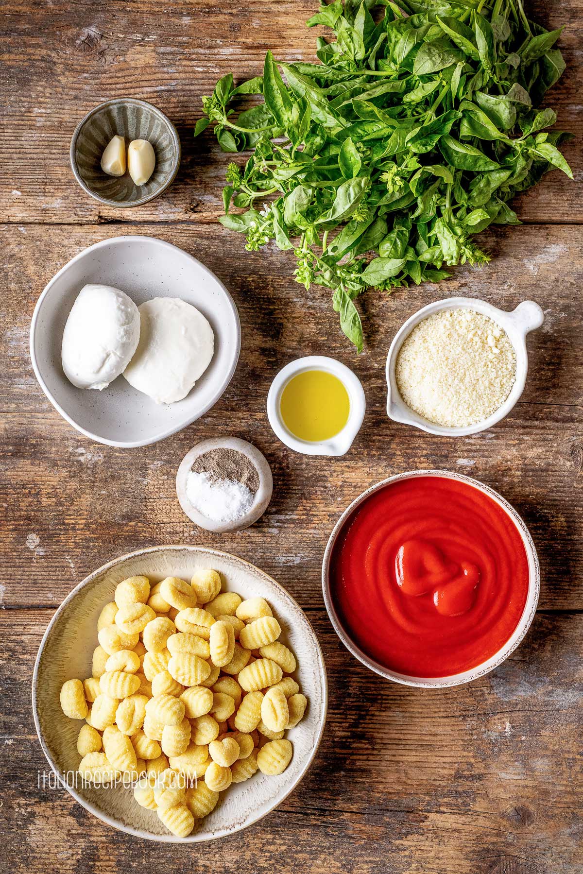 Ingredient for gnocchi alla sorrentina laid on a wooden surface.
