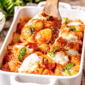 Gnocchi alla sorrentina scooped with a wooden spoon.