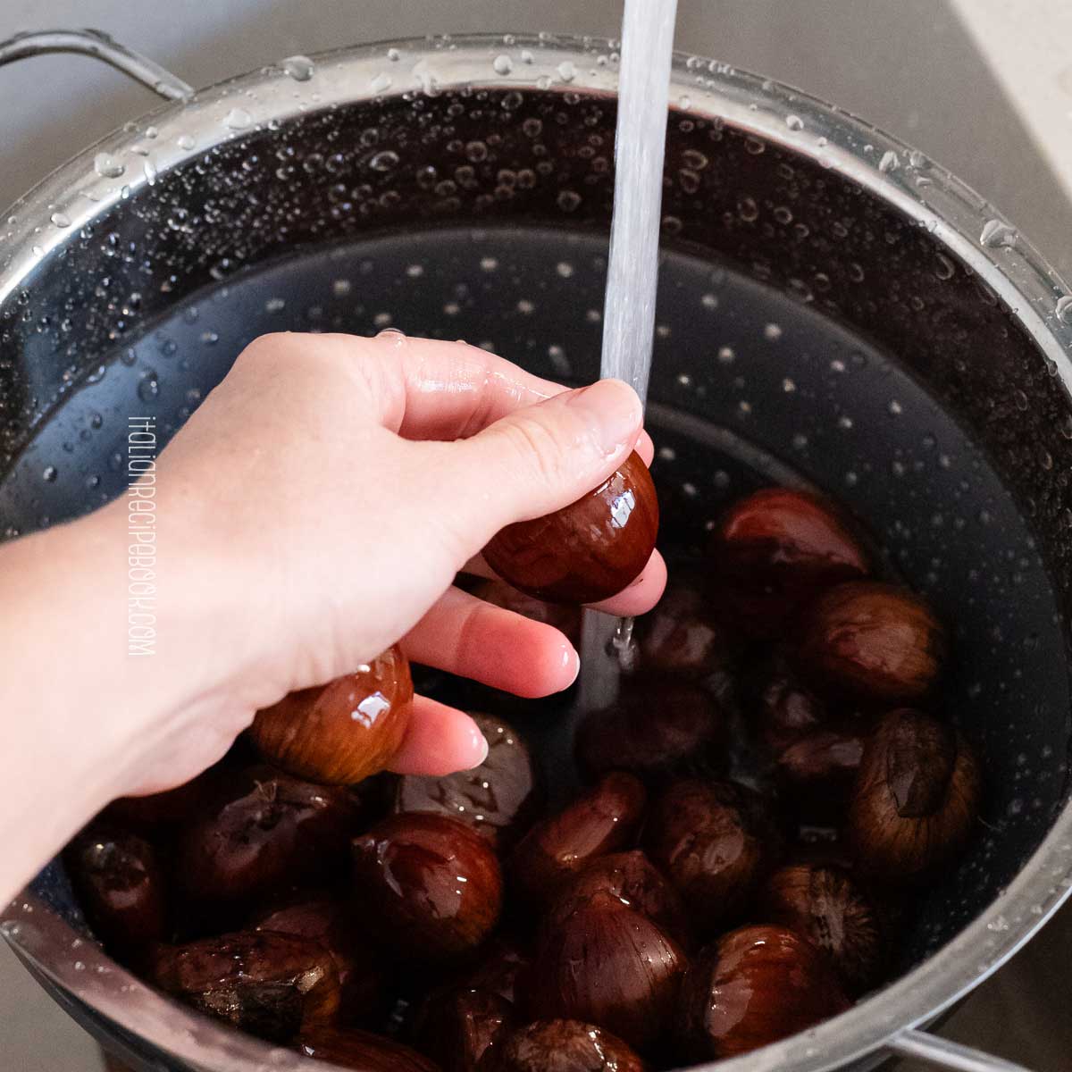 washing chestnuts under tap water