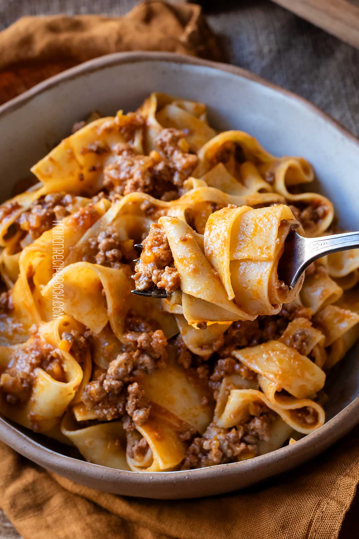 pappardelle alla bolognese on a fork