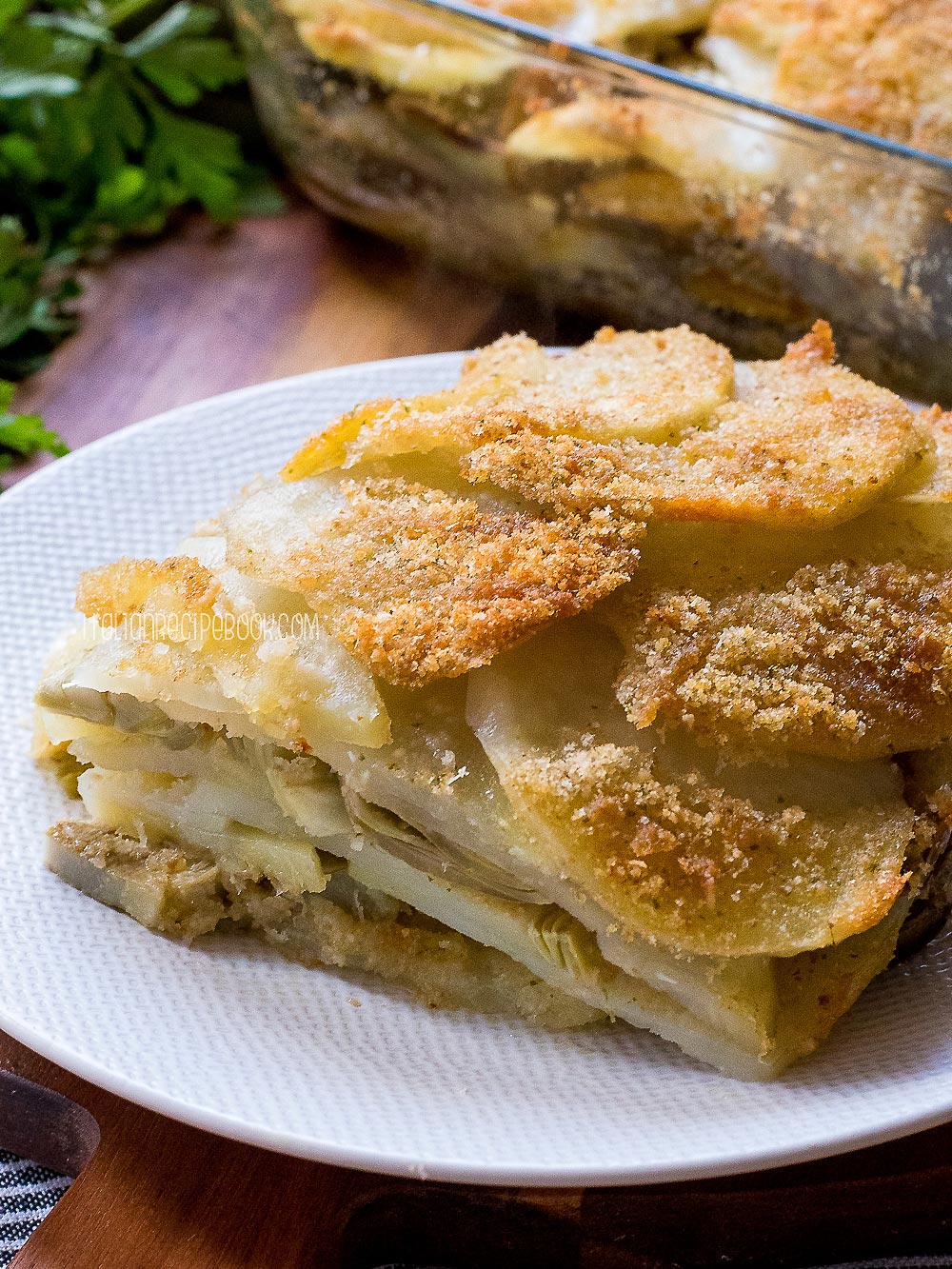 A piece of potato and artichoke gratin on a plate.