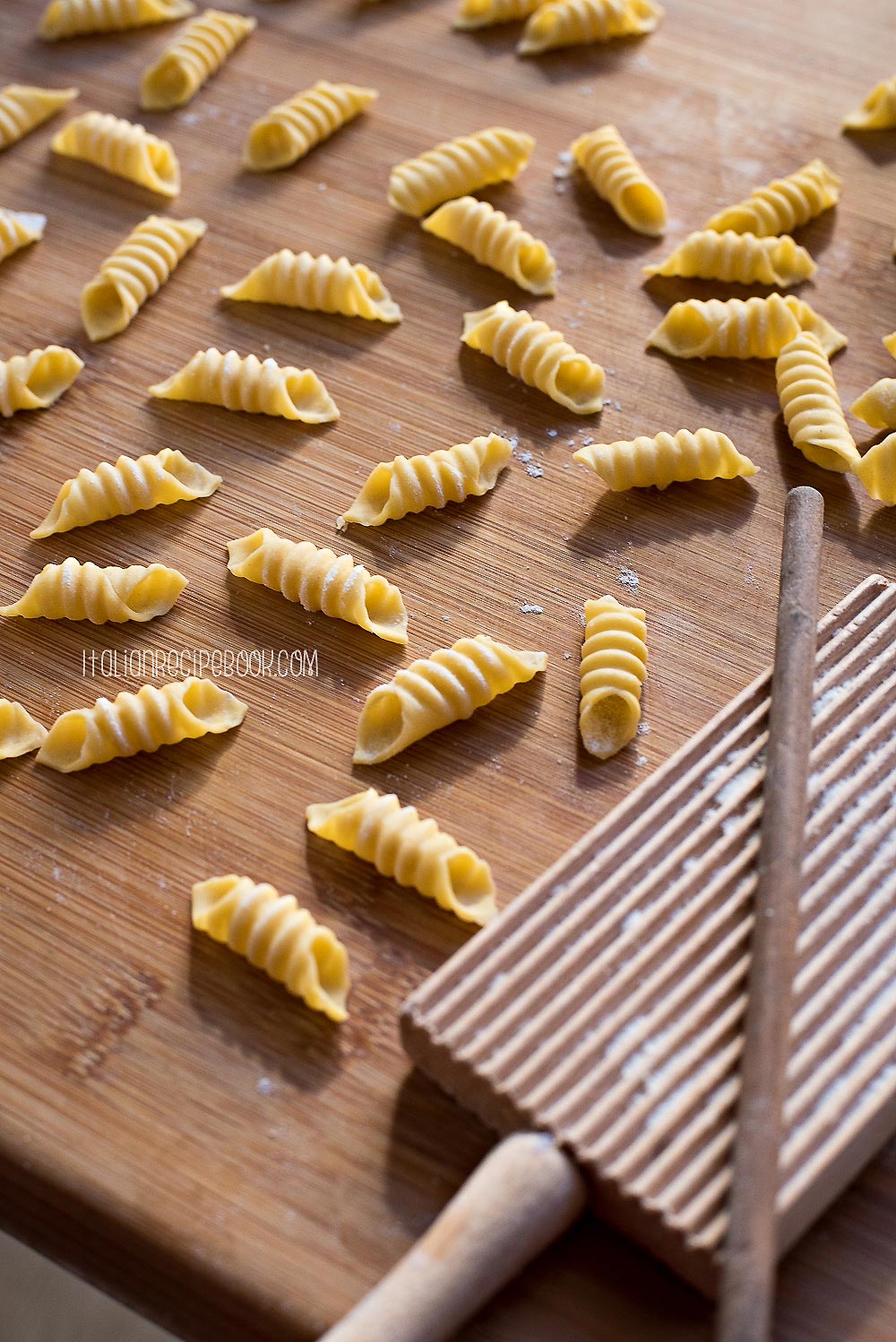 garganelli pasta on a wooden board