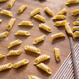 garganelli pasta on a wooden board