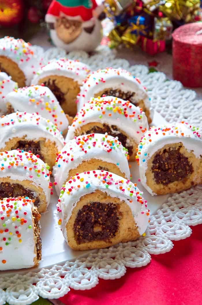Cookies on tray with Christmas decorations in the background. 