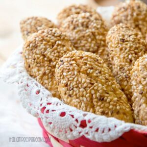Reginelle cookies coated with sesame seeds arranged in a basket.