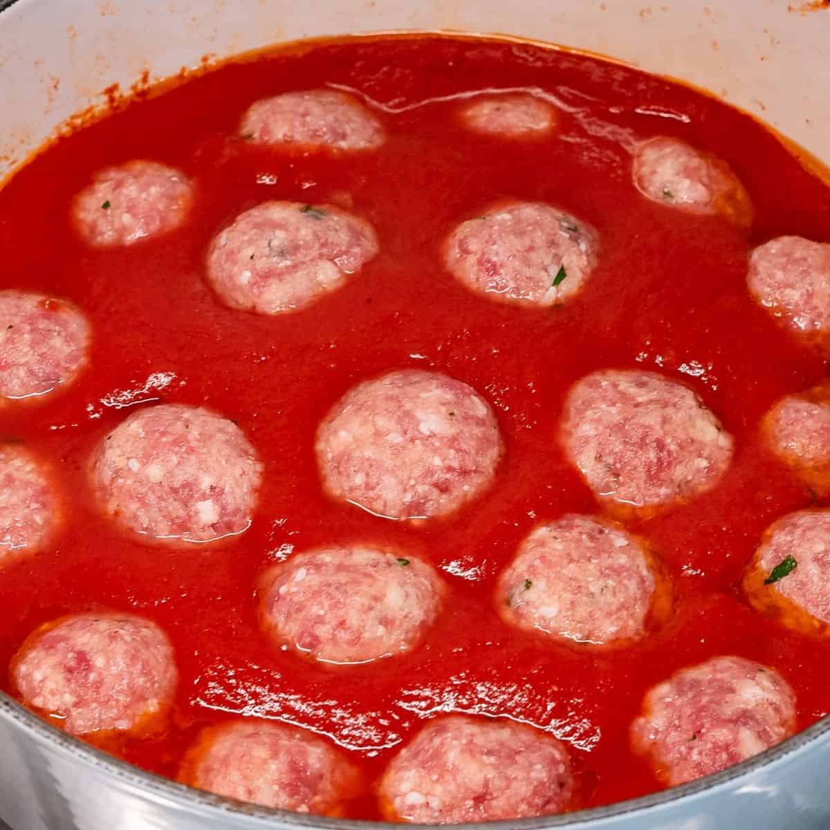 Polpette cooking in tomato sauce.