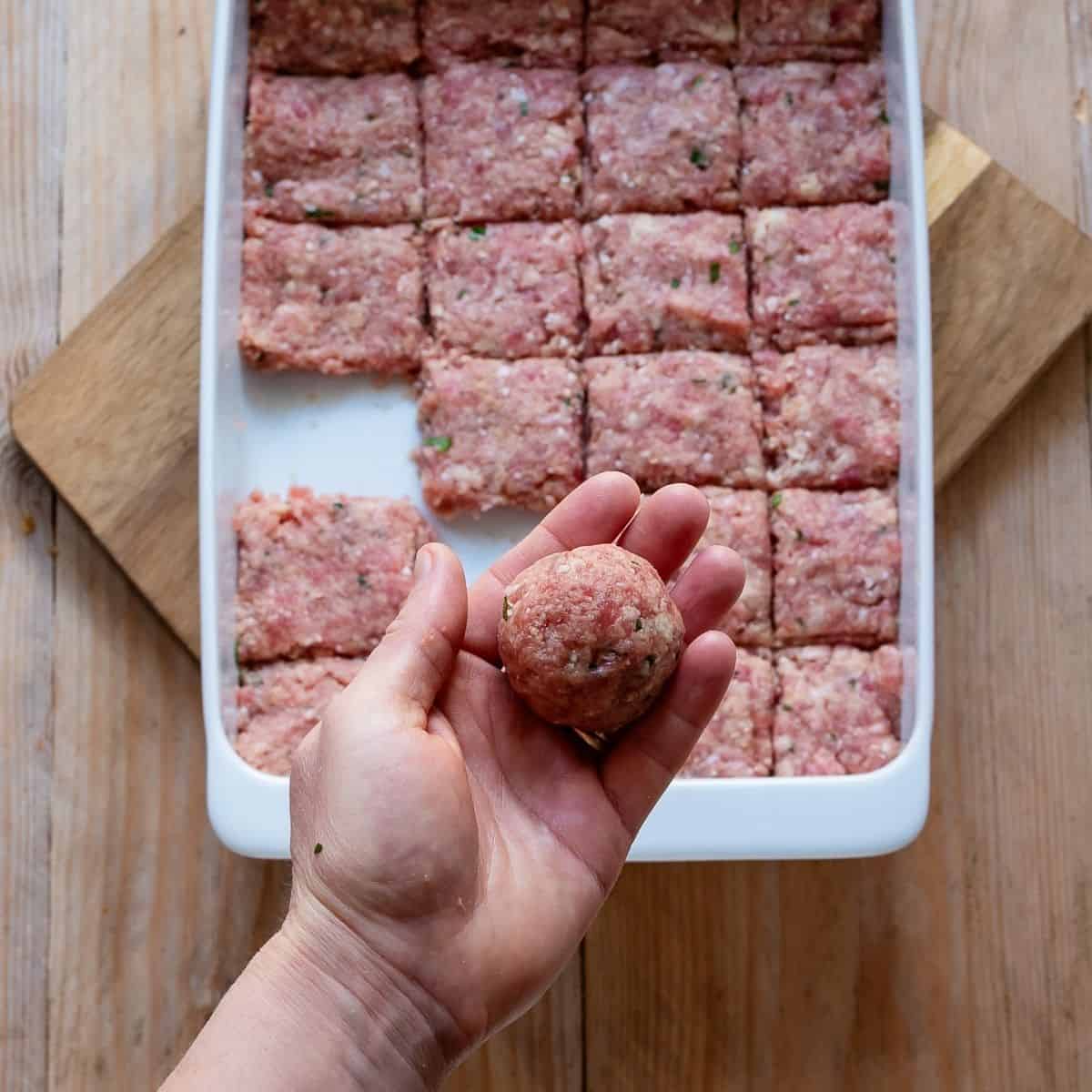 Rolling polpette into a ball.