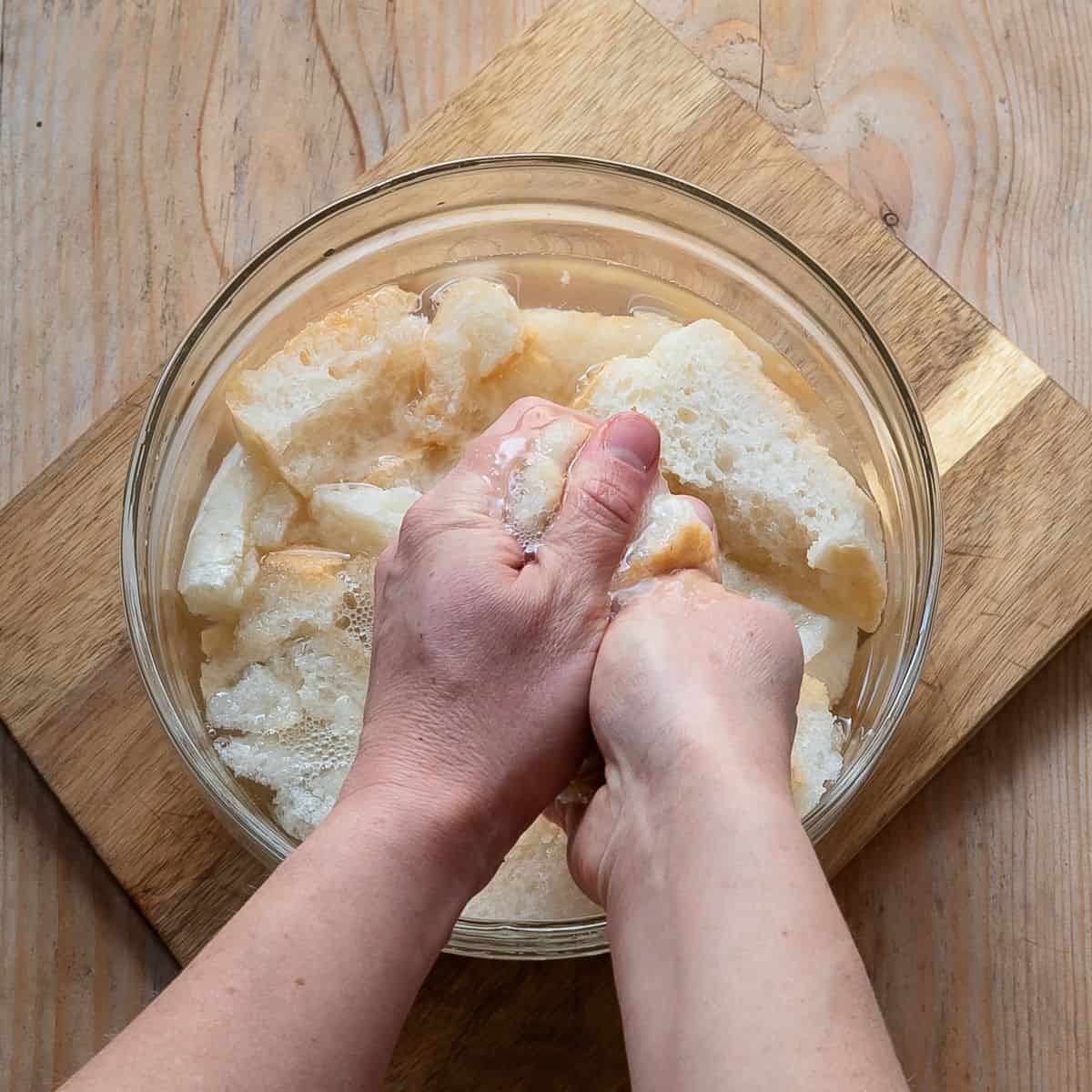 Squeezing soaked bread from excess water.
