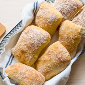 Italian ciabatta rolls in a basket.