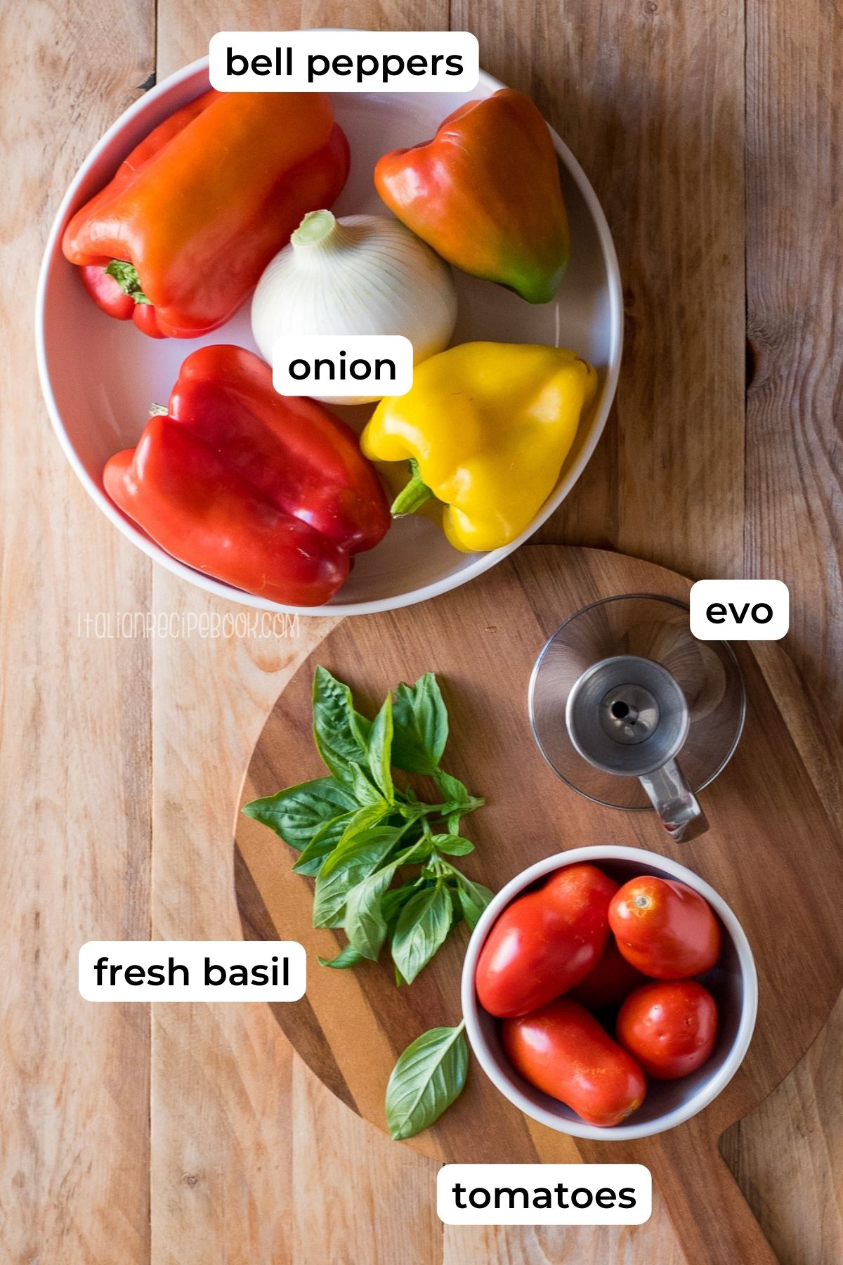 Ingredients needed for peperonata laid on a wooden surface.