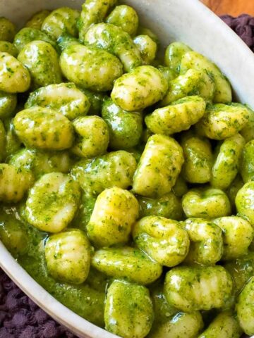 Gnocchi al pesto, super creamy, close up view.