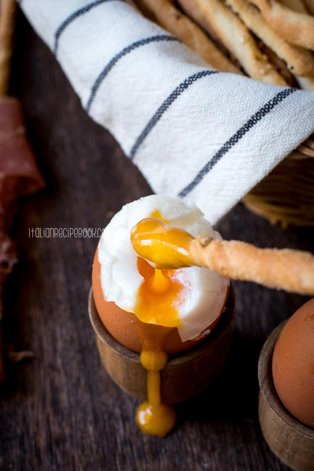 breadstick dunked in an egg yolk