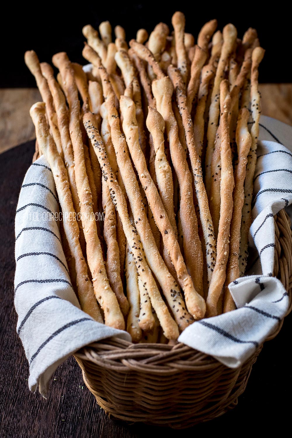 a bread basket full of grissini breadsticks