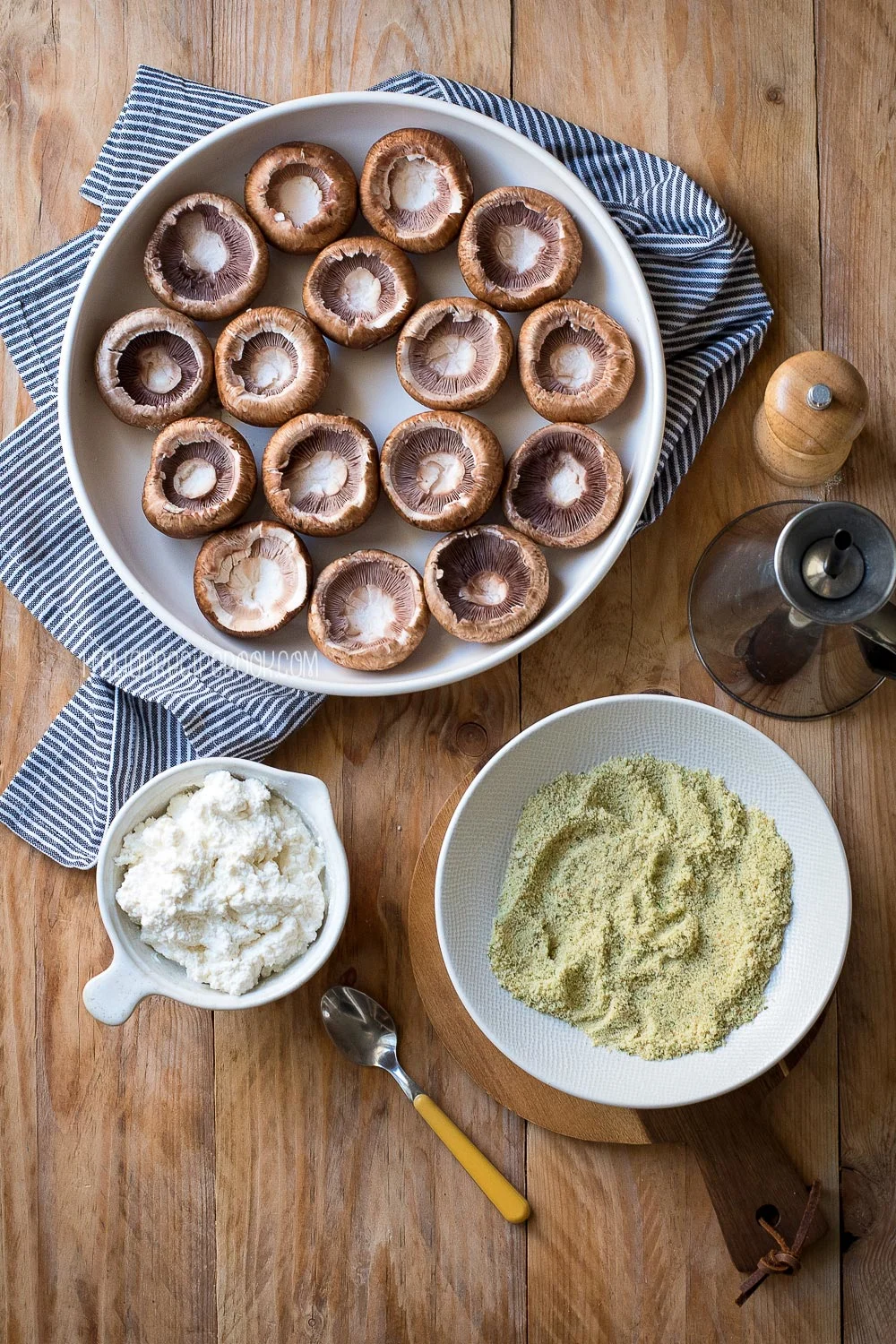 mushrooms, seasoned ricotta, breadcrumbs and olive oil on a wooden board