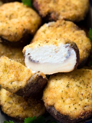 Baked ricotta stuffed mushroom in a serving dish.