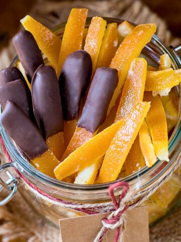 Candied orange peels in a glass jar.