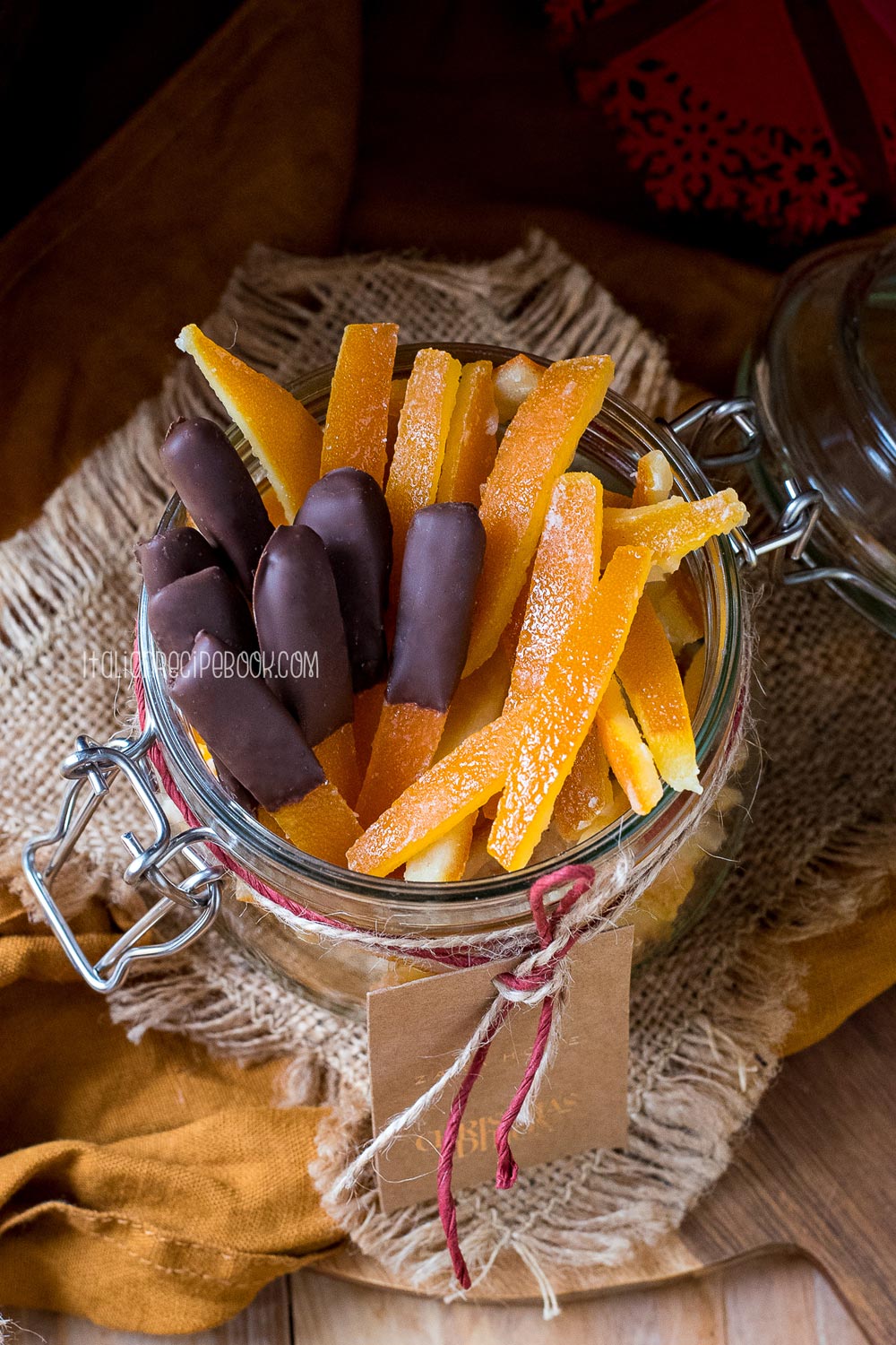 Chocolate covered and classic candied orange peels in a glass jar.
