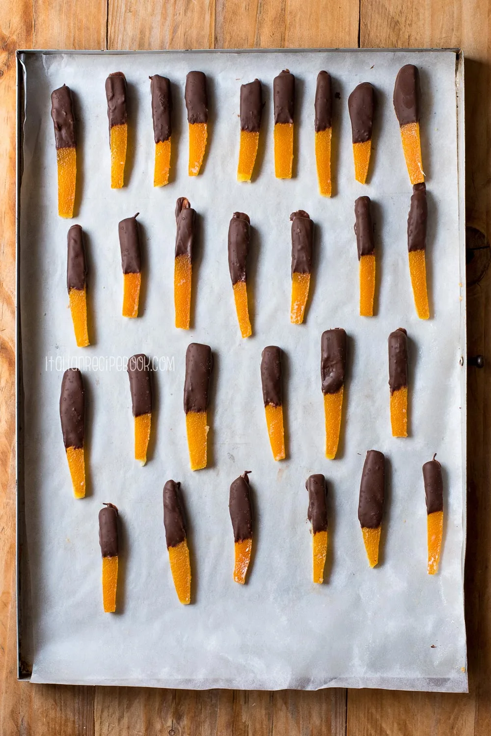 chocolate dipped candied oranges on a tray