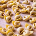 handmade tortellini on a wooden board
