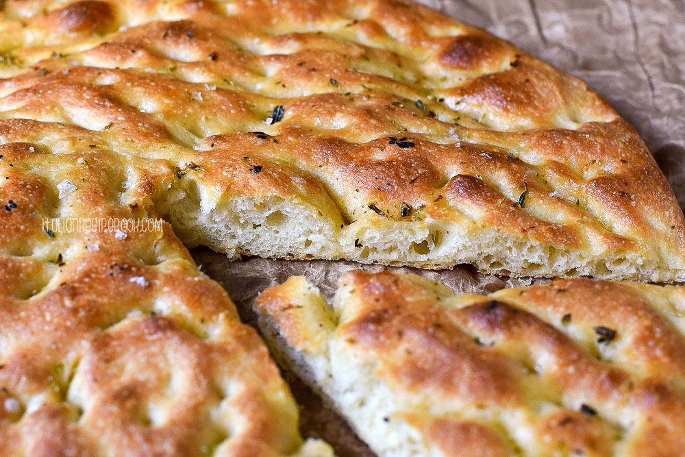 whole focaccia with a piece cut