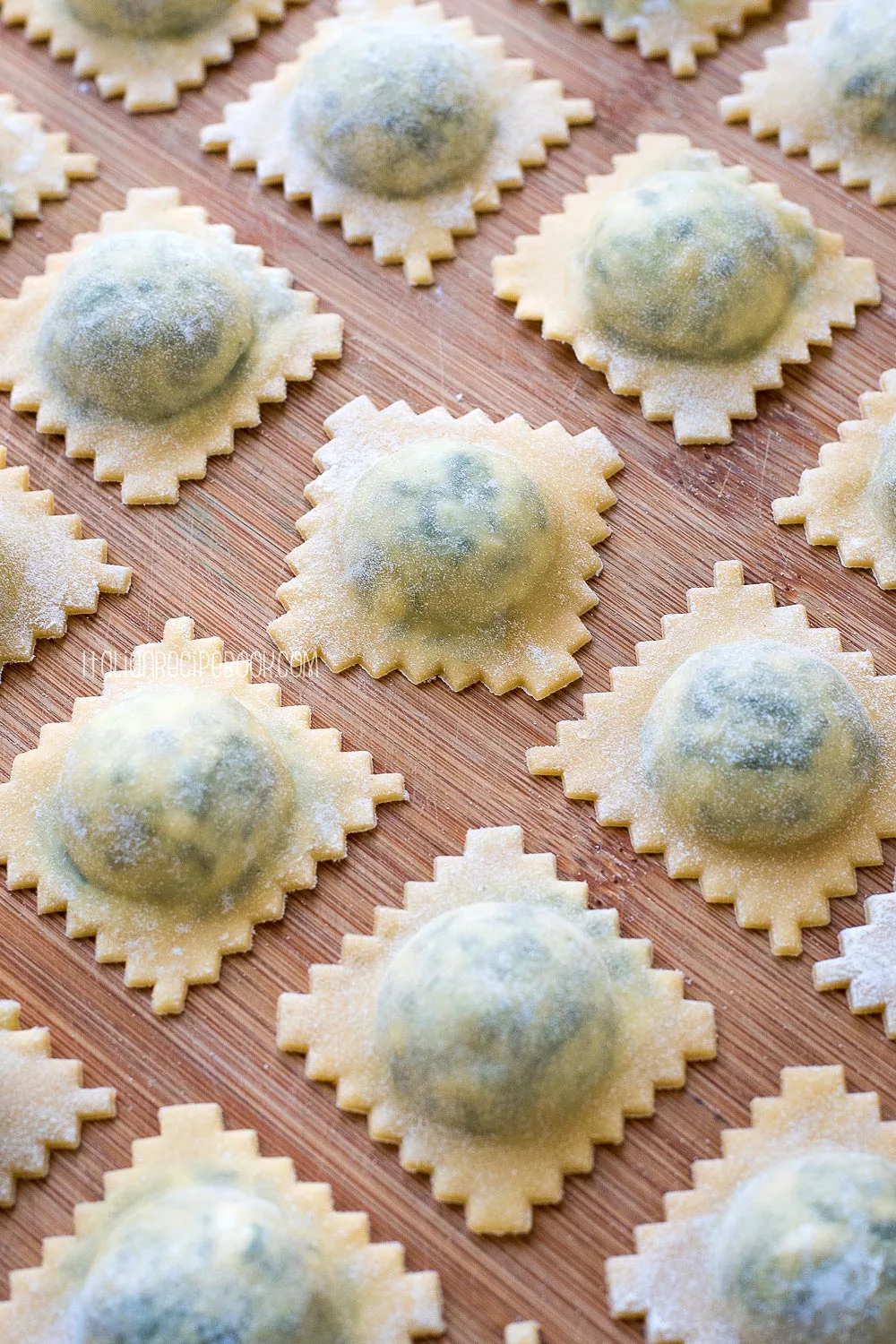 spinach and ricotta ravioli on a wooden board