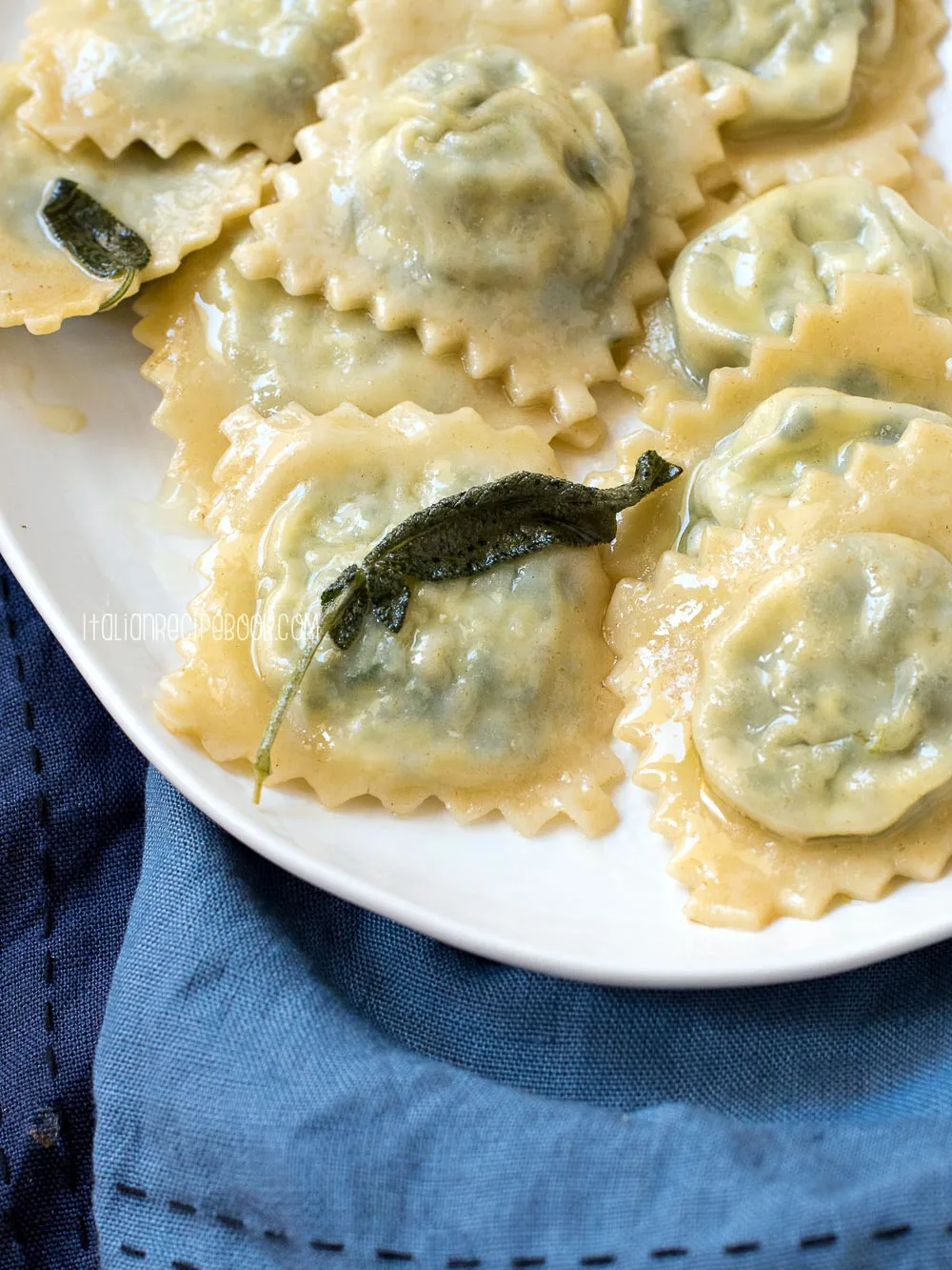 spinach and ricotta ravioli in sage butter sauce on a plate