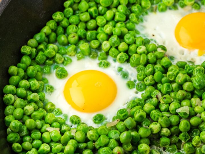 eggs and peas in a cast iron pan