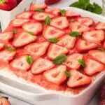 strawberry tiramisu topped with fresh strawberries and mint leaves