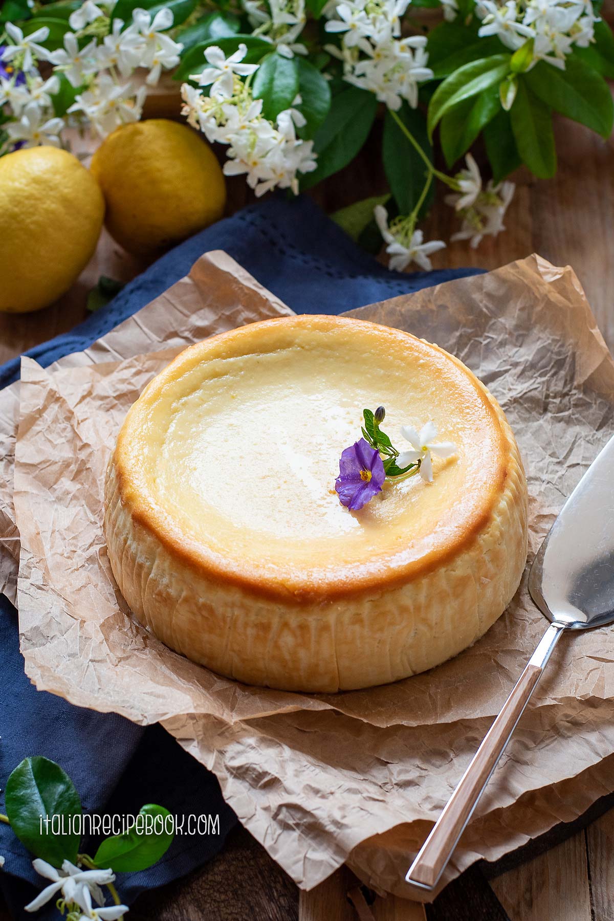lemon ricotta cheesecake with a cake spatula on the side