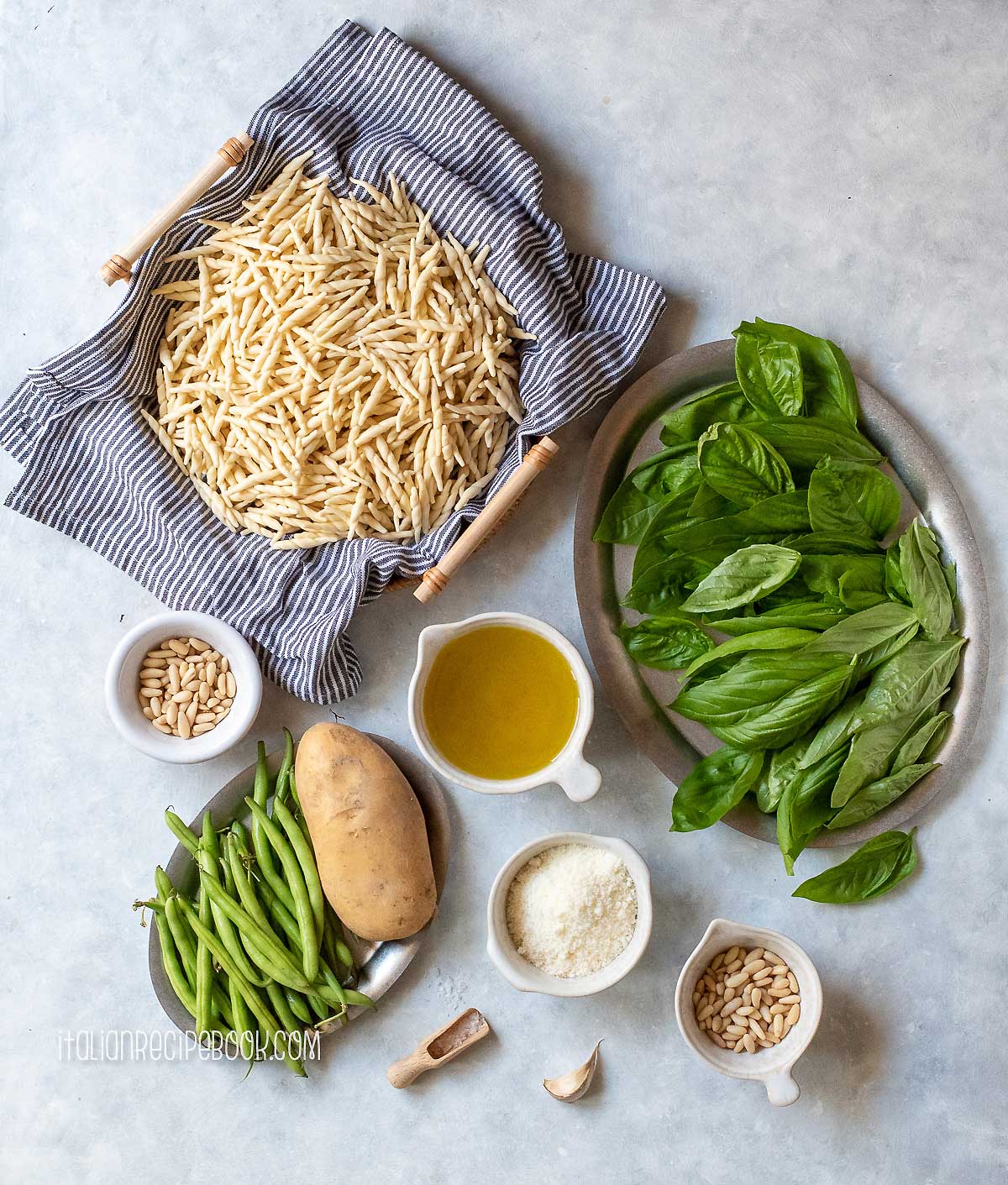 Ingredients needed to make pasta al pesto from scratch.