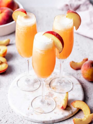 bellini cocktail in flute glasses