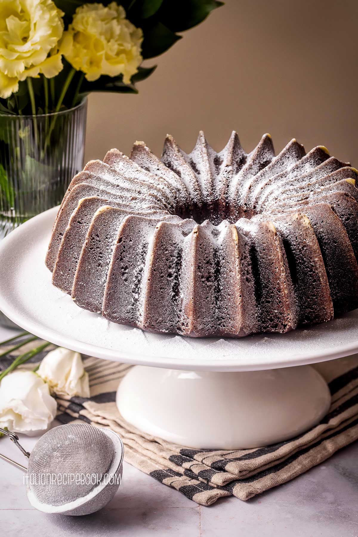 Chocolate ricotta cake on a cake stand.