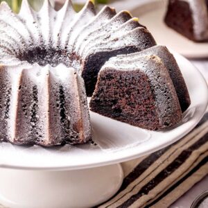 Chocolate ricotta cake on a cake stand.