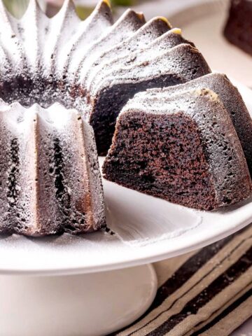 Chocolate ricotta cake on a cake stand.