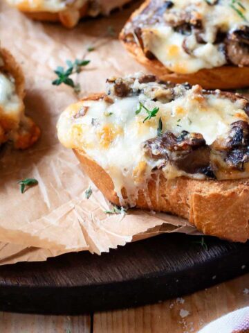 Mushrooms crostini with melted cheese.
