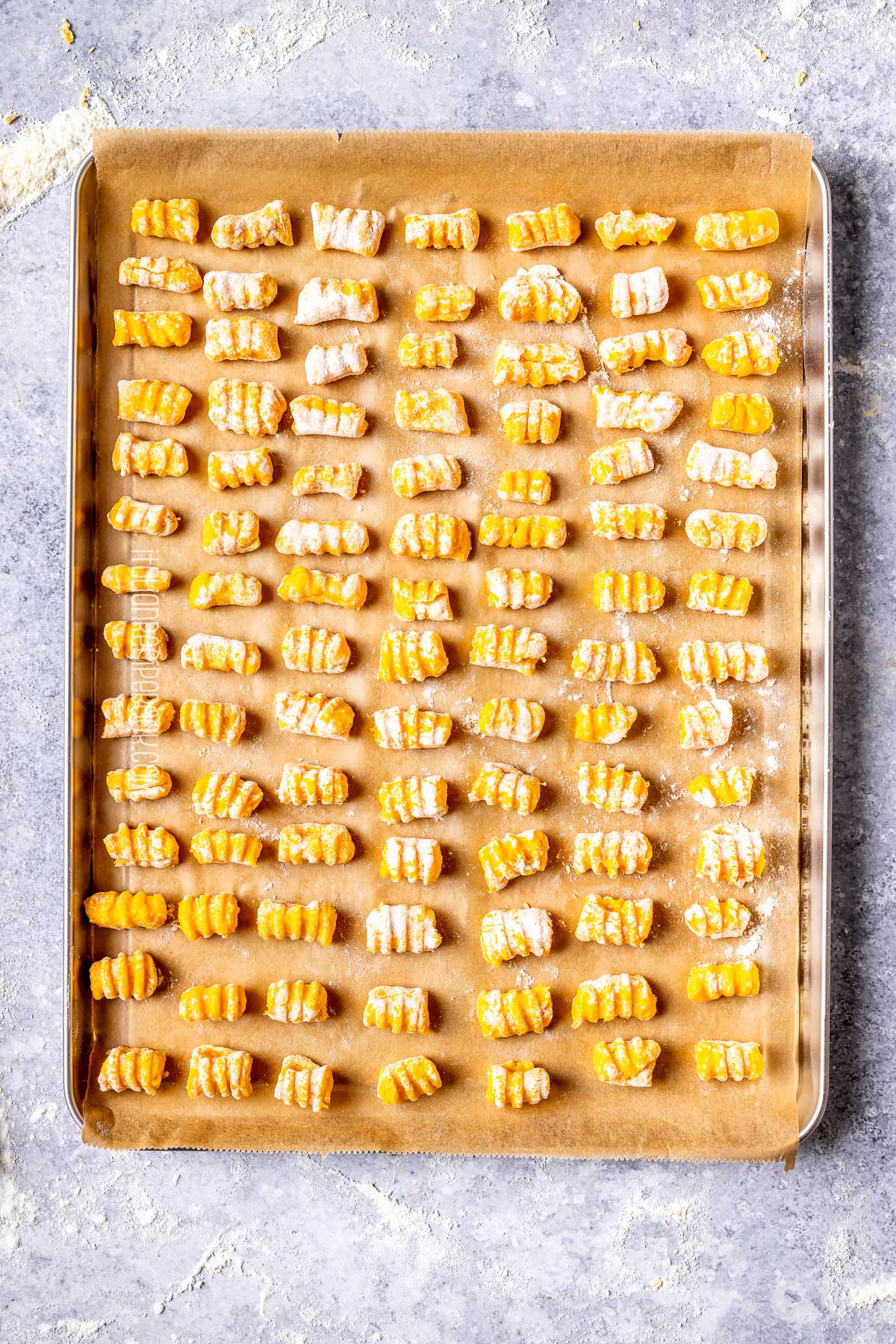 pumpkin gnocchi on a tray lines with parchment paper
