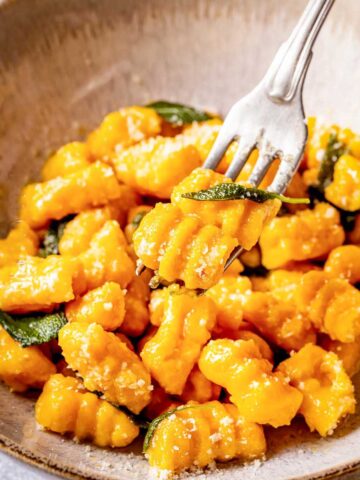 Soft pumpkin gnocchi on a fork.