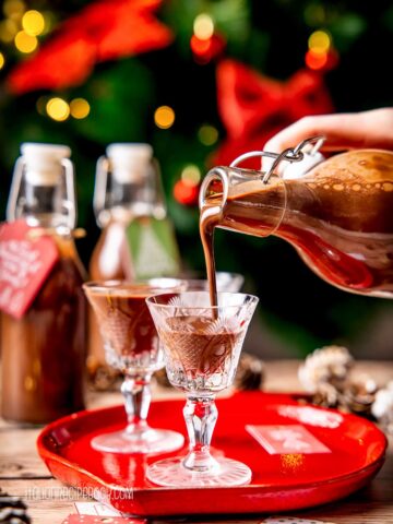 Pouring chocolate liqueur in a liqueur glass.