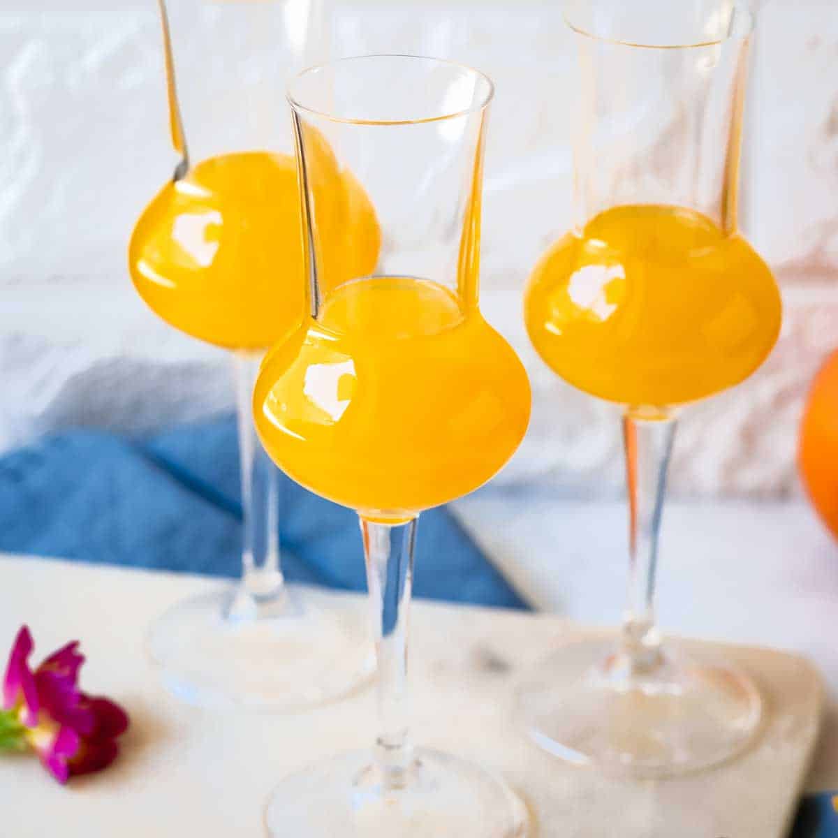 Orangecello in liqueur glasses.