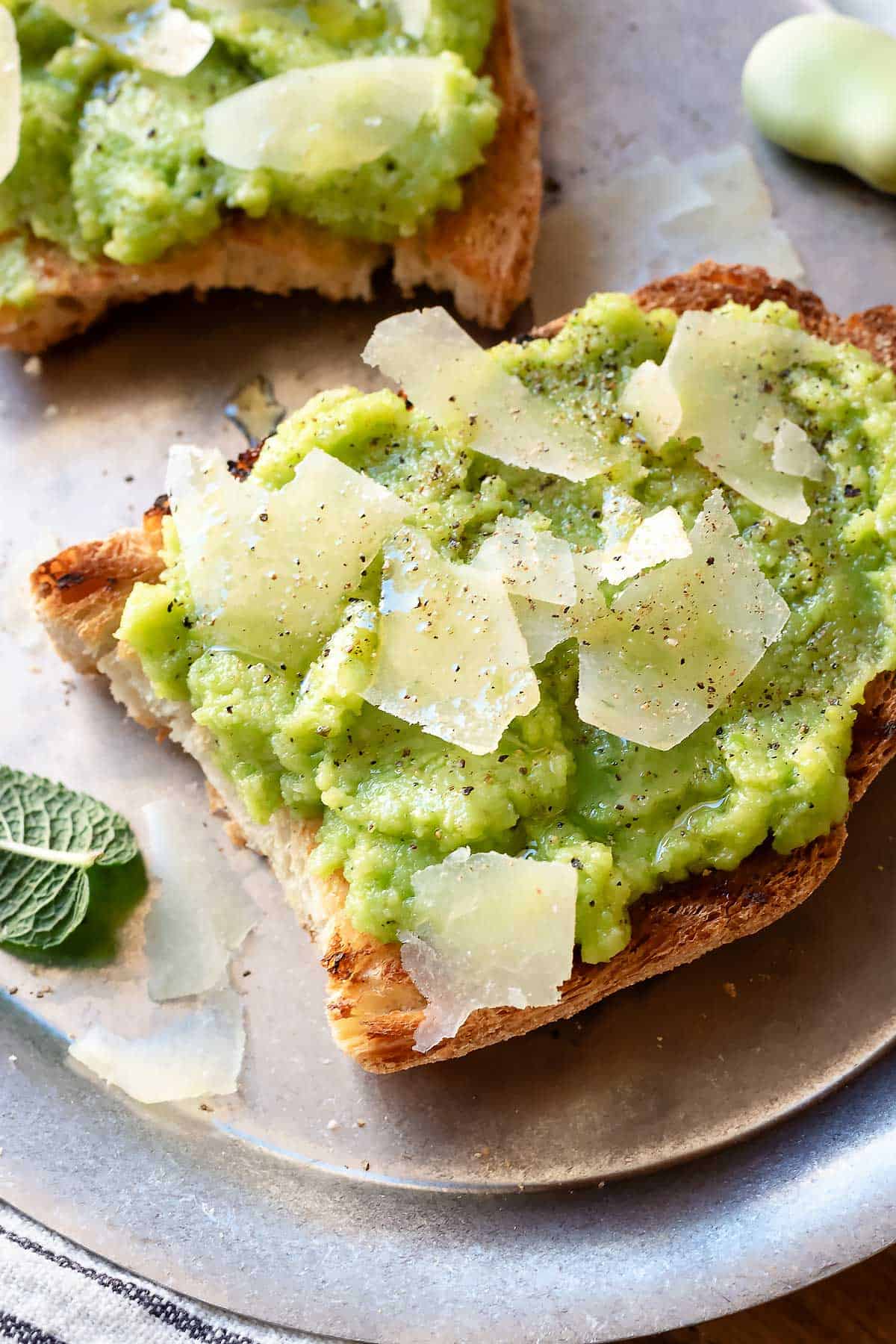 Crostini with fava bean pesto and shaved Pecorino cheese.