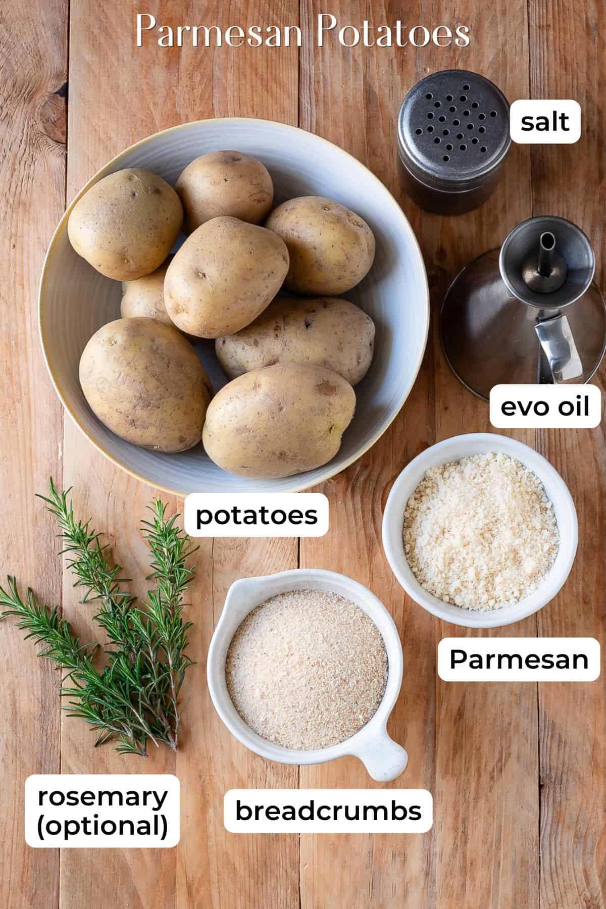 Ingredients need to make Parmesan potatoes laid on a wooden surface.