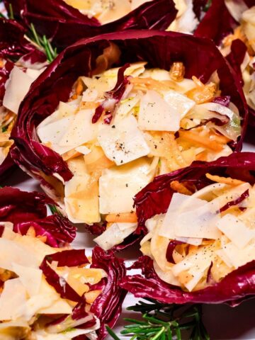Radicchio salad cups topped with shaved Parmesan.