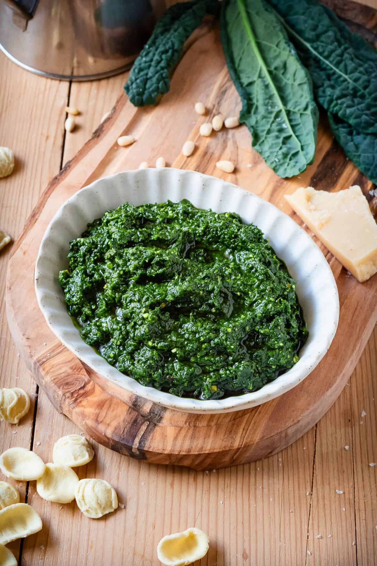 Tuscan kale pesto in a bowl on a wooden background.