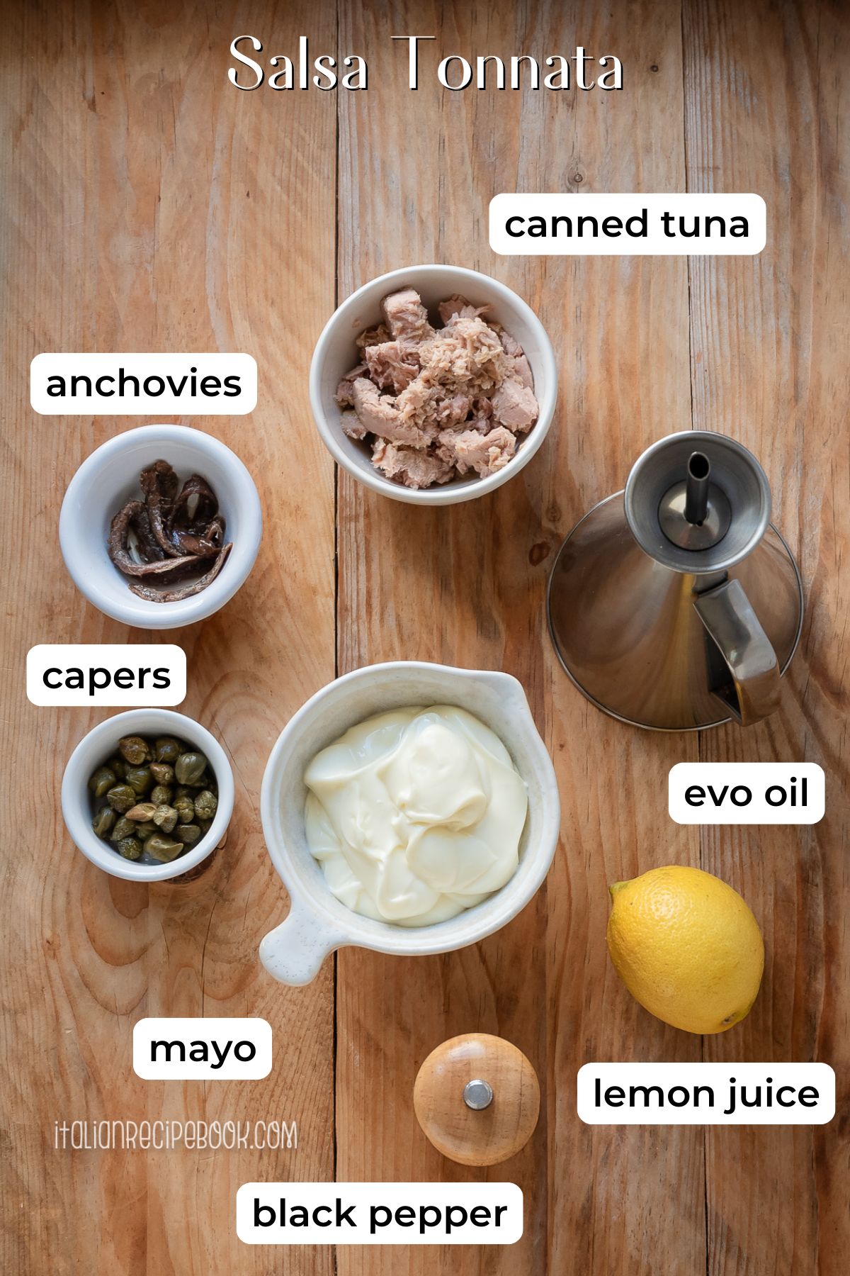 Salsa tonnata ingredients laid on a wooden surface.